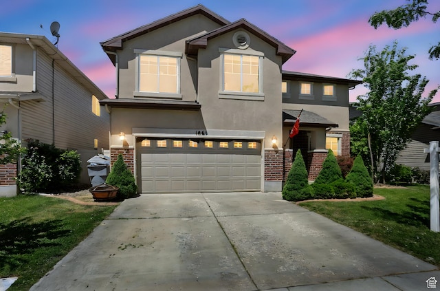 1061 N Bellingham Ct W, North Salt Lake, UT 84054 - traditional-style home with brick siding, stucco siding, an attached garage, concrete driveway, and a yard