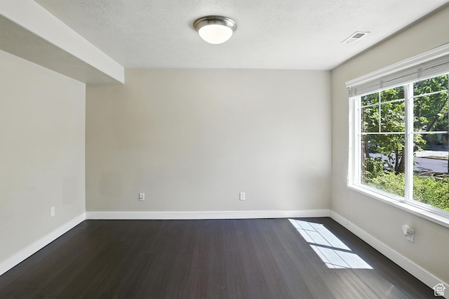 1061 N Bellingham Ct W, North Salt Lake, UT 84054 - spare room featuring dark wood-type flooring and a textured ceiling