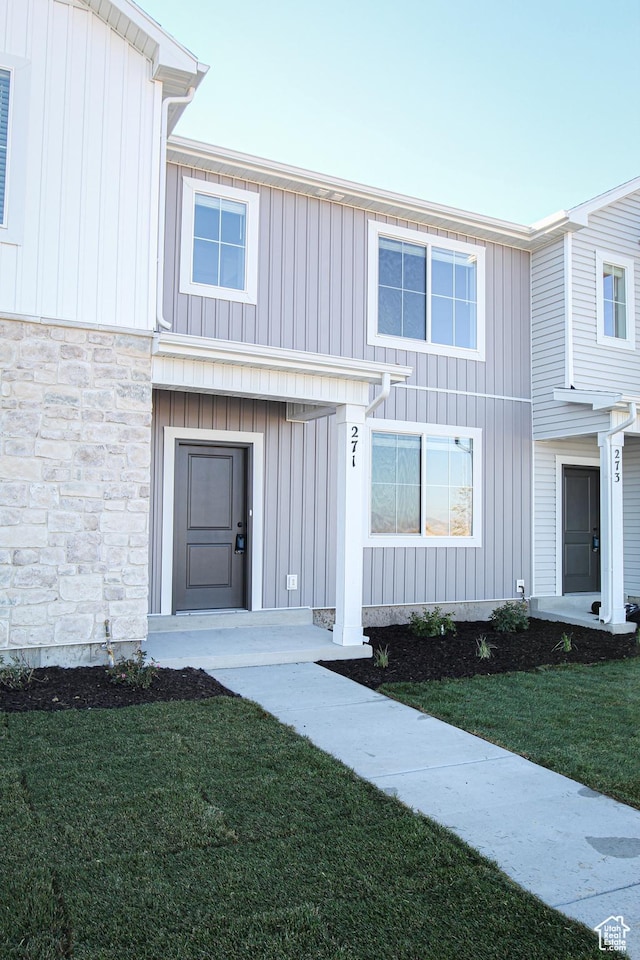 225 W 690 N, Smithfield, UT 84335 - view of front of home with a front yard, stone siding, and board and batten siding