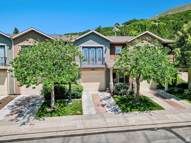 14857 S Treseder St, Draper, UT 84020 - view of front facade featuring stucco siding, driveway, and an attached garage