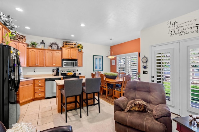14857 S Treseder St, Draper, UT 84020 - kitchen featuring stainless steel appliances, light countertops, open floor plan, a breakfast bar, and recessed lighting