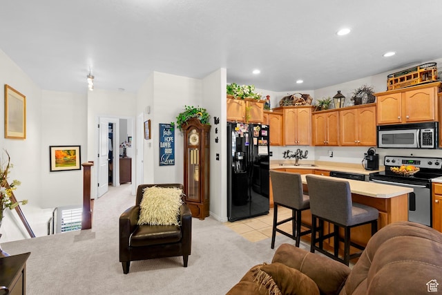 14857 S Treseder St, Draper, UT 84020 - kitchen featuring stainless steel appliances, light countertops, open floor plan, a breakfast bar area, and recessed lighting