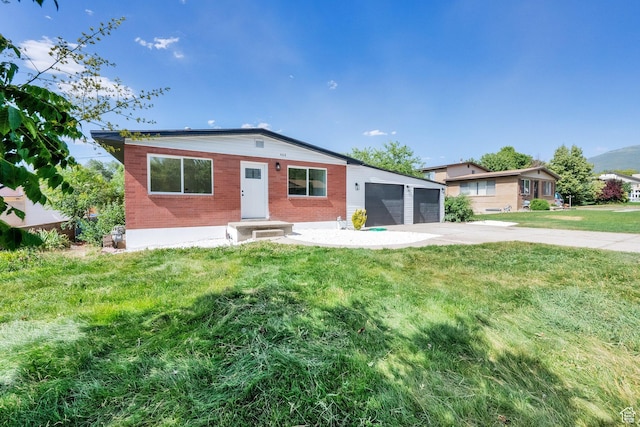 468 W 2400 S, Bountiful, UT 84010 - view of front of house featuring a front yard, a garage, driveway, and brick siding