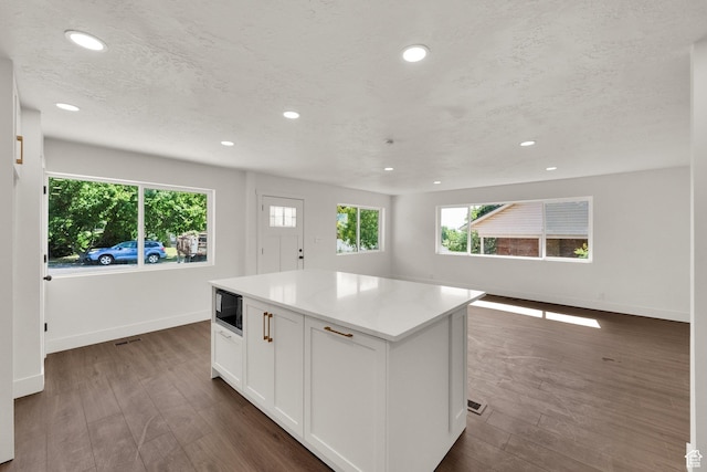 468 W 2400 S, Bountiful, UT 84010 - kitchen featuring recessed lighting, a kitchen island, white cabinetry, dark wood-style flooring, and black microwave