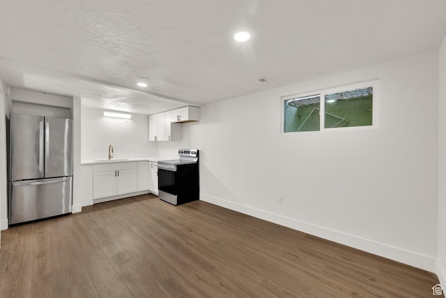 468 W 2400 S, Bountiful, UT 84010 - kitchen featuring appliances with stainless steel finishes, wood finished floors, light countertops, white cabinets, and recessed lighting