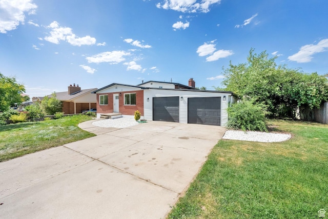 468 W 2400 S, Bountiful, UT 84010 - view of front of house with a front yard, an attached garage, concrete driveway, and a chimney