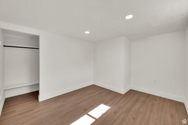 468 W 2400 S, Bountiful, UT 84010 - unfurnished bedroom featuring wood finished floors, recessed lighting, a closet, and a textured ceiling