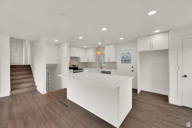 468 W 2400 S, Bountiful, UT 84010 - kitchen featuring stainless steel electric range, white cabinetry, recessed lighting, dark wood-style flooring, and a center island