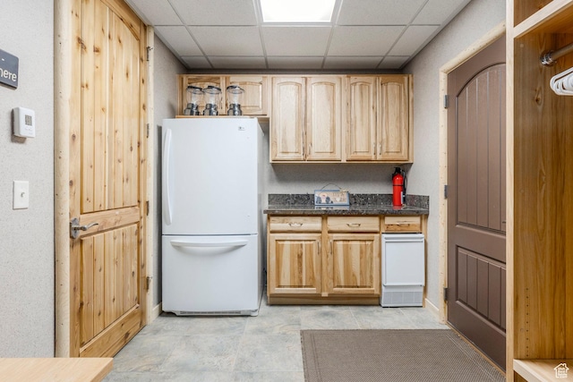 654 Sugar Pine Dr, Oakley, UT 84055 - kitchen featuring freestanding refrigerator, a drop ceiling, dark stone counters, and light tile patterned floors