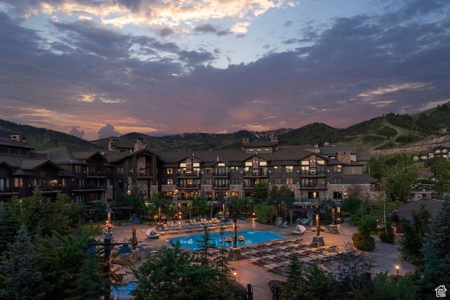 2100 W Frostwood Blvd Unit 3164, Park City, UT 84098 - pool at dusk featuring a mountain view and a community pool