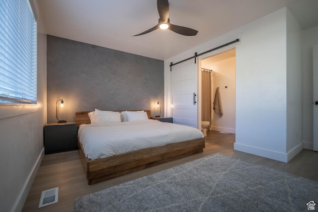 744 N 540 E, Smithfield, UT 84335 - bedroom with a barn door, wood finished floors, ensuite bathroom, and ceiling fan