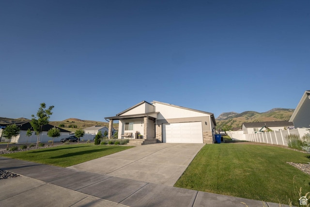744 N 540 E, Smithfield, UT 84335 - view of front of home featuring a garage, a mountain view, and concrete driveway