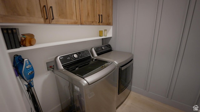 744 N 540 E, Smithfield, UT 84335 - laundry area featuring separate washer and dryer, cabinet space, and light wood-type flooring