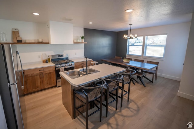 744 N 540 E, Smithfield, UT 84335 - kitchen with open shelves, appliances with stainless steel finishes, brown cabinetry, light wood-style flooring, and a kitchen breakfast bar