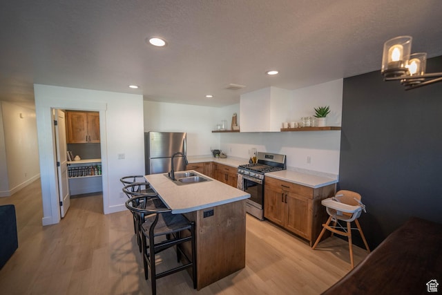 744 N 540 E, Smithfield, UT 84335 - kitchen featuring stainless steel appliances, open shelves, light wood-style floors, brown cabinets, and light countertops