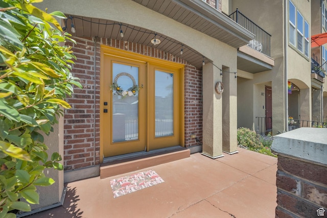 169 W Barry Links Way S, Salt Lake, UT 84115 - property entrance with stucco siding, brick siding, and a balcony