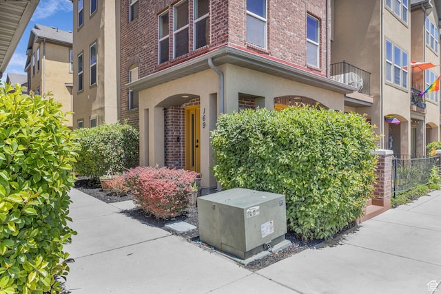 169 W Barry Links Way S, Salt Lake, UT 84115 - doorway to property featuring brick siding and stucco siding