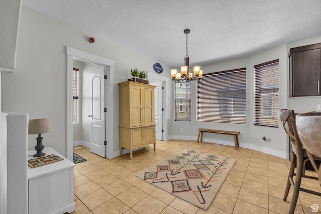 169 W Barry Links Way S, Salt Lake, UT 84115 - dining area featuring light tile patterned flooring, a chandelier, and a textured ceiling