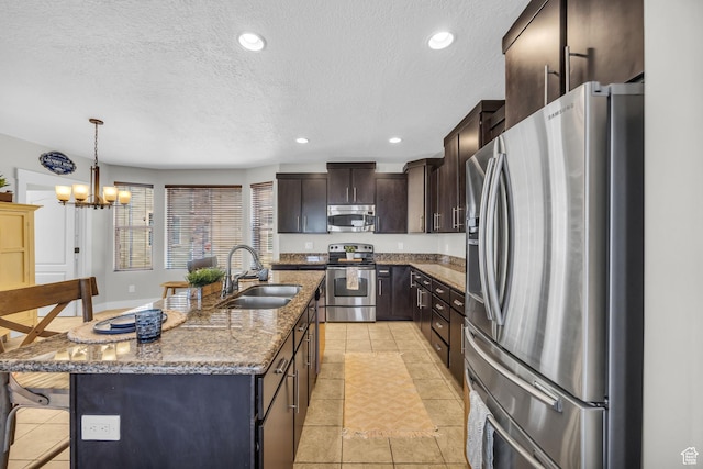 169 W Barry Links Way S, Salt Lake, UT 84115 - kitchen with appliances with stainless steel finishes, a textured ceiling, stone counters, light tile patterned flooring, and dark brown cabinets