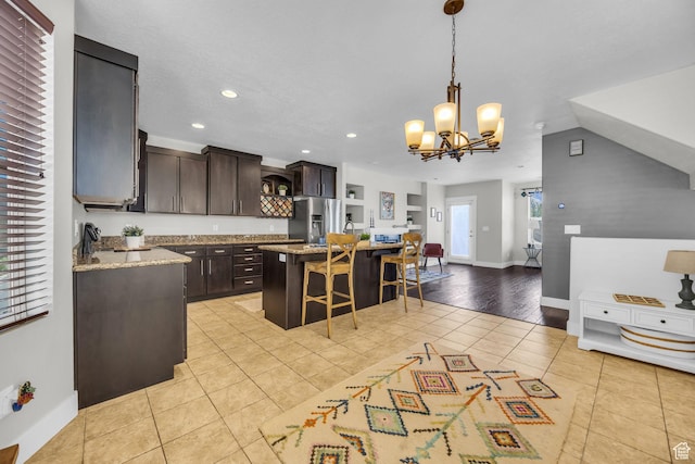 169 W Barry Links Way S, Salt Lake, UT 84115 - kitchen with stainless steel refrigerator with ice dispenser, light tile patterned floors, dark brown cabinets, a kitchen bar, and recessed lighting