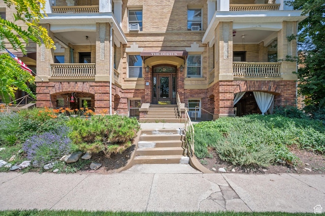 557 E 1 St Ave Unit 12, Salt Lake City, UT 84103 - property entrance with brick siding, a balcony, and cooling unit