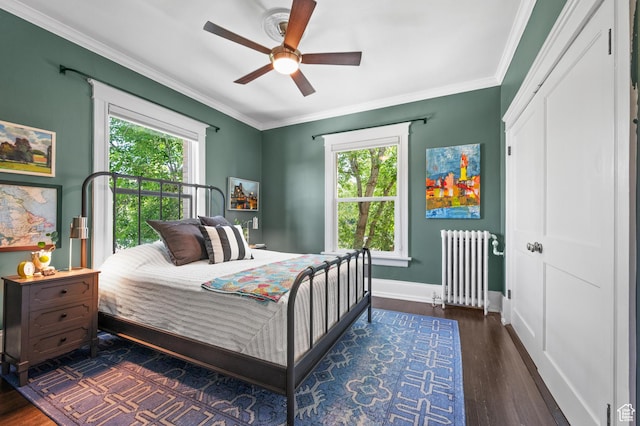557 E 1 St Ave Unit 12, Salt Lake City, UT 84103 - bedroom featuring radiator heating unit, multiple windows, ornamental molding, wood finished floors, and a ceiling fan