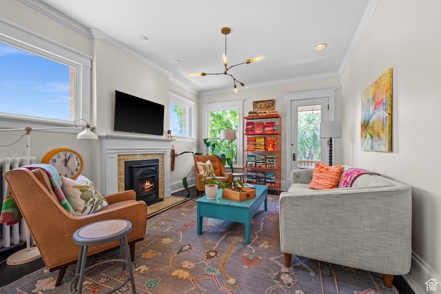 557 E 1 St Ave Unit 12, Salt Lake City, UT 84103 - living room with a chandelier, ornamental molding, and a lit fireplace