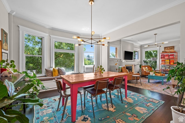 557 E 1 St Ave Unit 12, Salt Lake City, UT 84103 - dining room with dark wood-type flooring, a glass covered fireplace, a chandelier, and crown molding