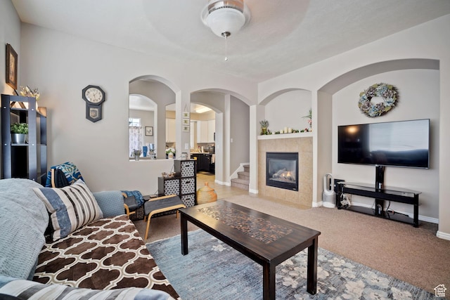 452 N Kent Dr, North Salt Lake, UT 84054 - living area with a tiled fireplace, light colored carpet, and arched walkways