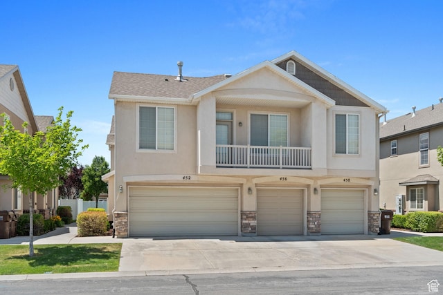 452 N Kent Dr, North Salt Lake, UT 84054 - view of property with stone siding, an attached garage, concrete driveway, and stucco siding