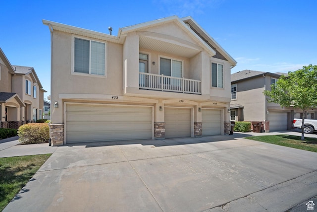 452 N Kent Dr, North Salt Lake, UT 84054 - townhome / multi-family property featuring stone siding, a garage, stucco siding, and driveway
