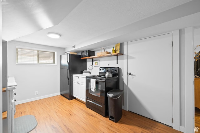 440 E Willow Ave, Murray, UT 84107 - kitchen featuring black appliances, light wood-style flooring, open shelves, light countertops, and a textured ceiling