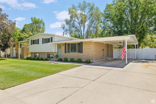 440 E Willow Ave, Murray, UT 84107 - split level home featuring brick siding, driveway, and an attached carport