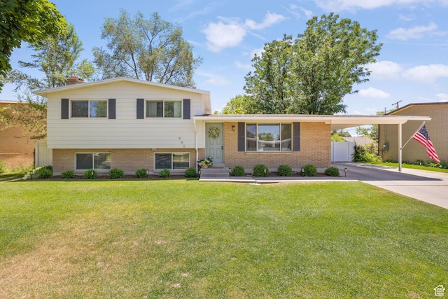 440 E Willow Ave, Murray, UT 84107 - split level home with driveway, brick siding, an attached carport, and a chimney