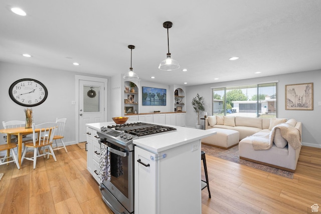 440 E Willow Ave, Murray, UT 84107 - kitchen featuring stainless steel gas range, white cabinets, light wood finished floors, and recessed lighting