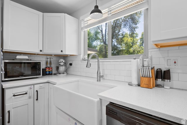 440 E Willow Ave, Murray, UT 84107 - kitchen featuring stainless steel microwave, dishwashing machine, backsplash, white cabinets, and healthy amount of natural light