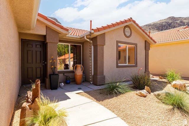 2403 S 725 W, Hurricane, UT 84737 - doorway to property with stucco siding, a mountain view, and a tile roof