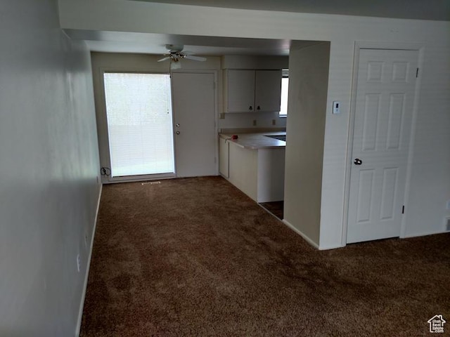 1949 E Jeremy Dr S, Salt Lake City, UT 84121 - kitchen with carpet flooring, white cabinets, a ceiling fan, and light countertops