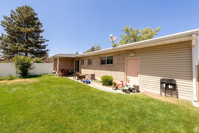 6204 S Jeremy Cir, Salt Lake City, UT 84121 - rear view of house featuring brick siding and a patio