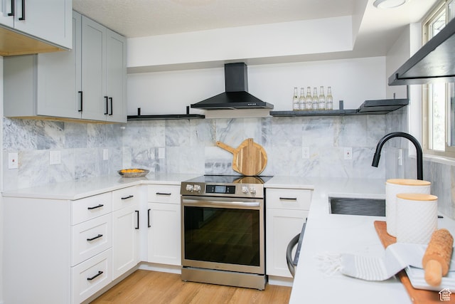 522 W 1060 N, Clinton, UT 84015 - kitchen with electric range, wall chimney exhaust hood, open shelves, and light countertops