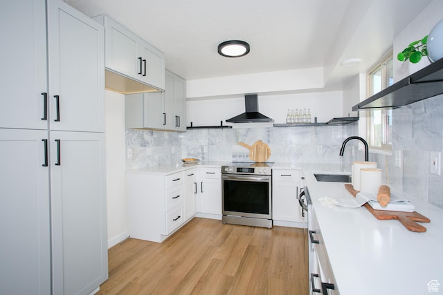 522 W 1060 N, Clinton, UT 84015 - kitchen featuring stainless steel electric stove, wall chimney range hood, light countertops, light wood-style floors, and decorative backsplash