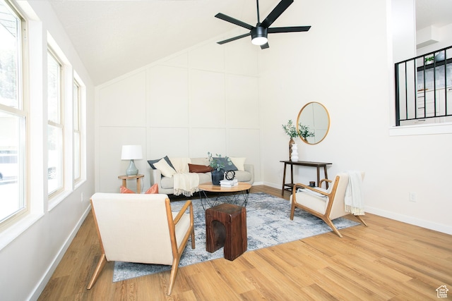 522 W 1060 N, Clinton, UT 84015 - living area featuring wood finished floors, ceiling fan, plenty of natural light, high vaulted ceiling, and a decorative wall