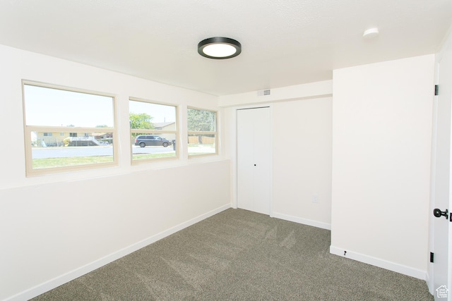 522 W 1060 N, Clinton, UT 84015 - unfurnished bedroom featuring dark carpet and a closet