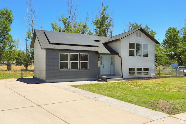 522 W 1060 N, Clinton, UT 84015 - split level home with solar panels, a shingled roof, and brick siding