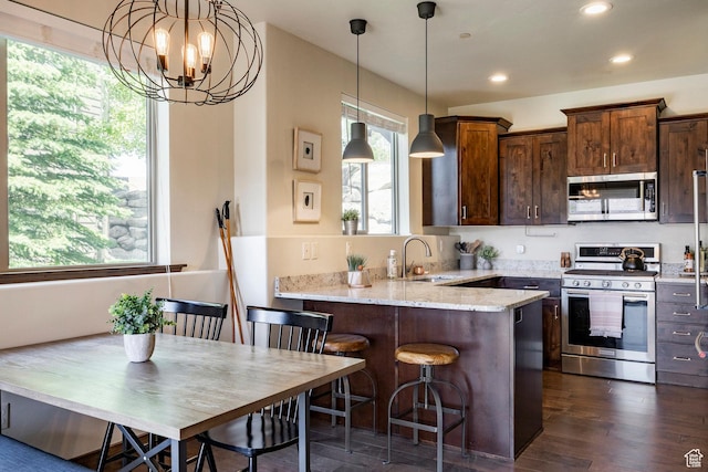 1261 W Black Rock Trl Unit 39D, Kamas, UT 84036 - kitchen with appliances with stainless steel finishes, light stone countertops, recessed lighting, dark wood-style floors, and a chandelier