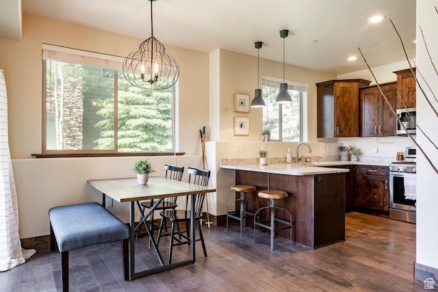 1261 W Black Rock Trl Unit 39D, Kamas, UT 84036 - kitchen featuring appliances with stainless steel finishes, a kitchen bar, healthy amount of natural light, dark wood finished floors, and recessed lighting