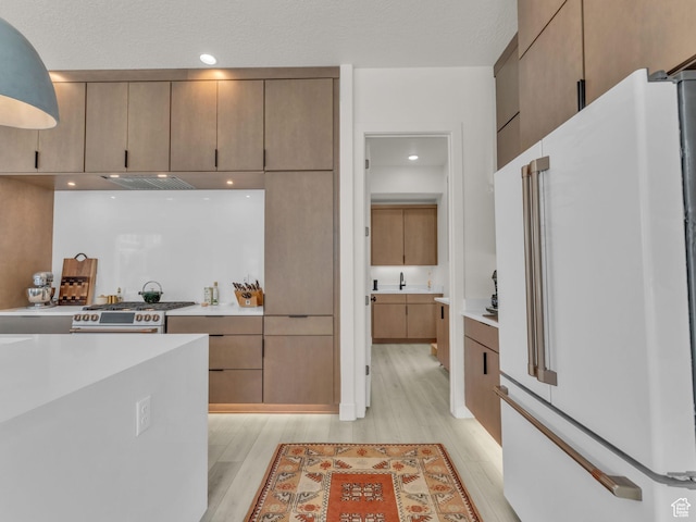 11609 S Dorian Dr W, South Jordan, UT 84009 - kitchen featuring freestanding refrigerator, stainless steel stove, light wood finished floors, and light countertops