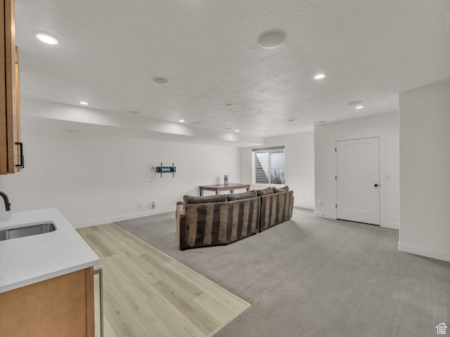11609 S Dorian Dr W, South Jordan, UT 84009 - living room featuring a textured ceiling, recessed lighting, and light wood finished floors