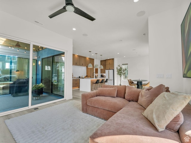 11609 S Dorian Dr W, South Jordan, UT 84009 - living room with ceiling fan, light wood finished floors, plenty of natural light, and recessed lighting