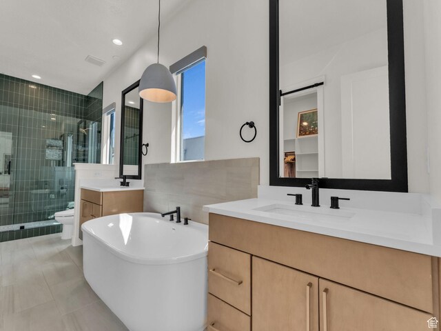 11609 S Dorian Dr W, South Jordan, UT 84009 - full bath featuring a shower stall, vanity, a freestanding bath, and tile patterned flooring